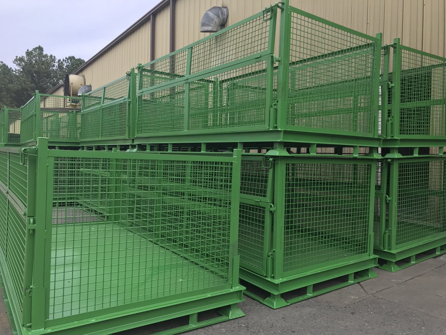 Green wire-mesh returnable steel containers built by Southern Perfection Fabrication in Byron, GA