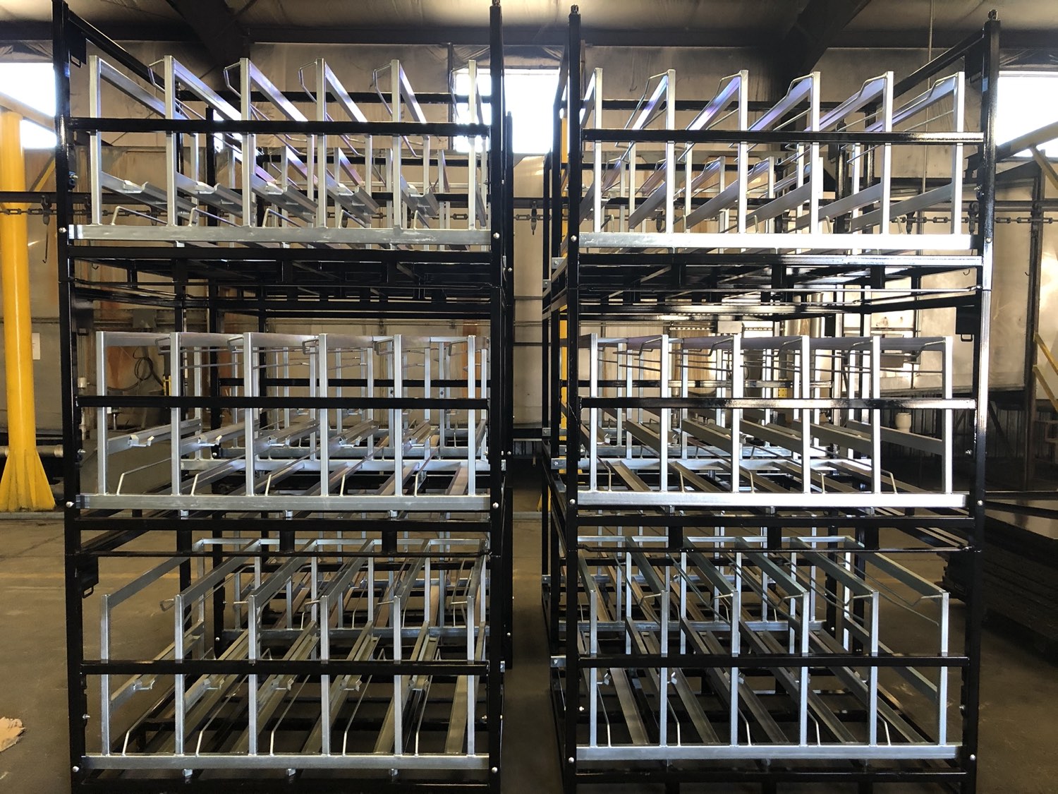 Rows of custom work-in-process (WIP) racks and carts built by Southern Perfection Fabrication in Byron, GA